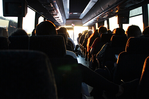coaching staff on a charter bus